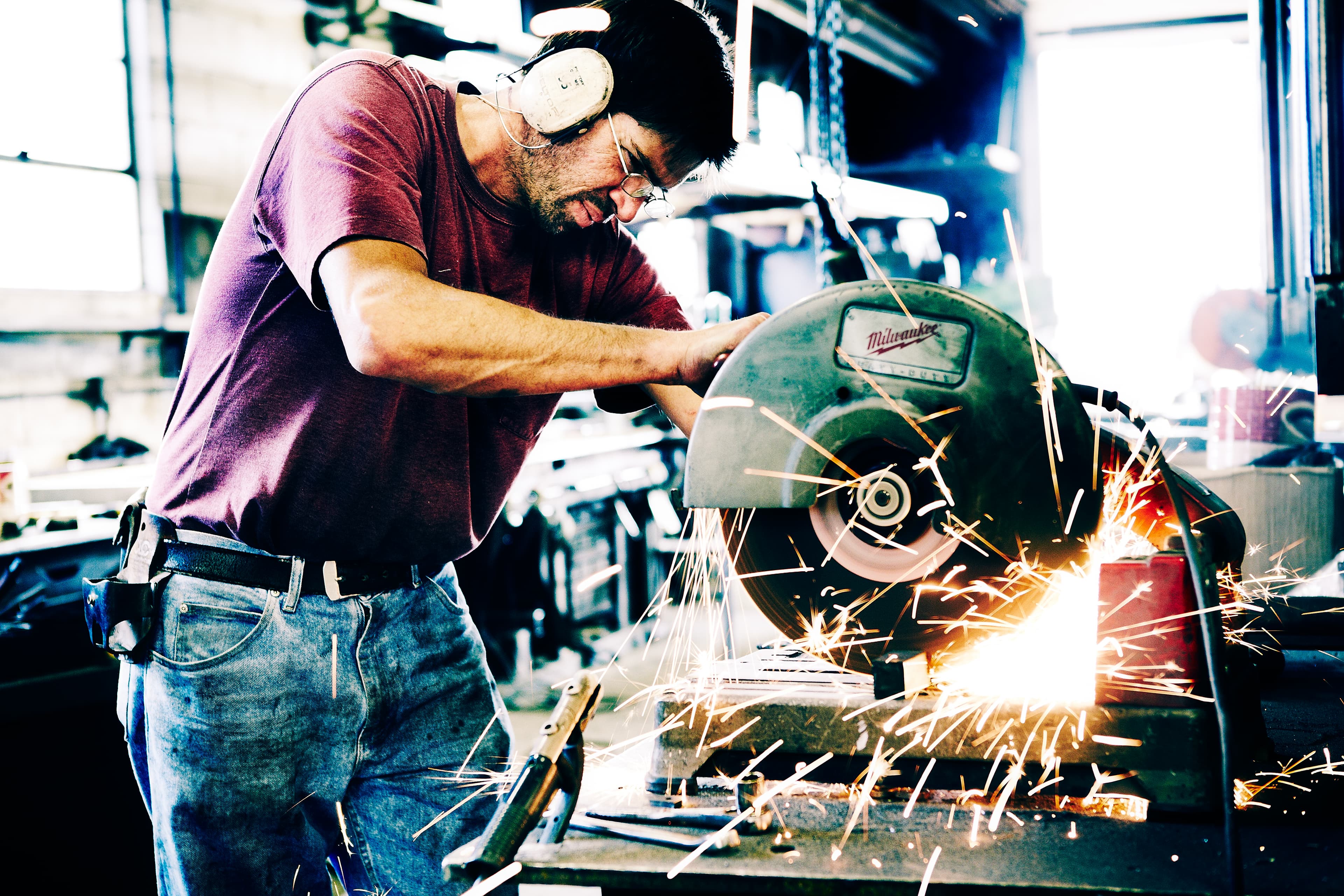 Ironworker cutting metal with sparks flying